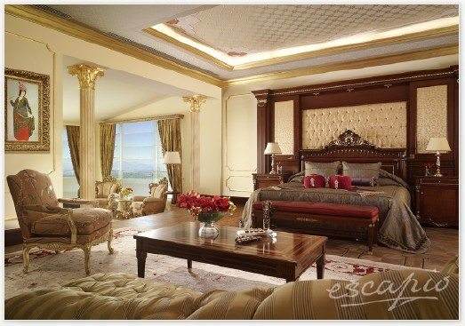 A large bedroom with ornate decor welcomes the guests at Mardan Palace.