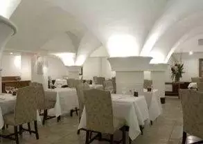 The Cellar - Dublin, Ireland: An arched dining room with white tables and chairs.