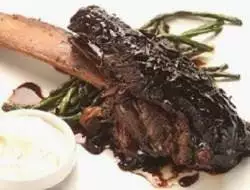 A plate of ribs with sauce and green beans, enjoyed during a girlfriend getaway in NYC.