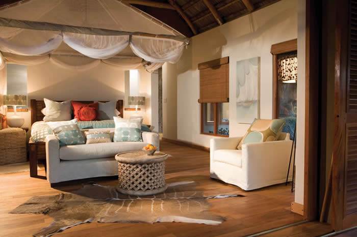 Serene bedroom with a canopy bed and wooden floor.