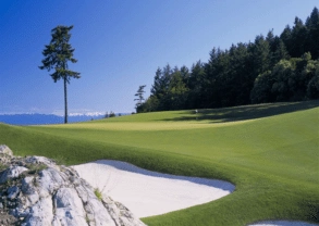 A golf course with sand bunkers and trees at Canada's Beautiful Pacific Coast Resort.