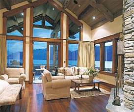 Experience the untouched beauty of nature in Blanket Bay, where a living room offers a fireplace and enchanting lake view.