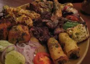 A plate with a variety of food on it, featuring authentic Indian flavors at Bukhara in New Delhi.