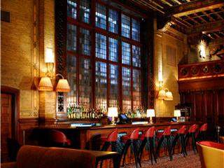 A large room with a bar and chairs, perfect for those who wouldn't want to move in.