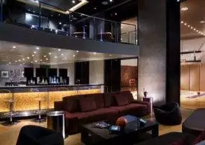 A large living room with couches and a bar located in Steve Wynn Casino, Las Vegas.