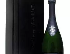 A bottle of Krug champagne next to a black box.
