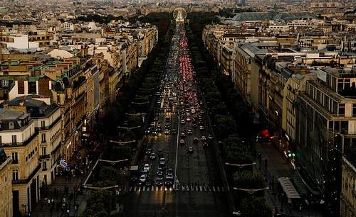 The Eiffel Tower can be seen from a city street.