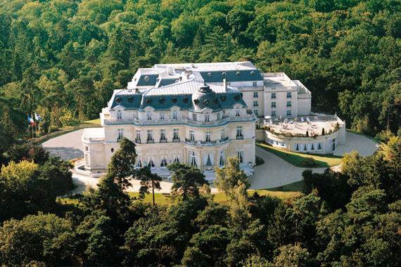 An aerial view of the Historical Tiara Chateau Hotel, a large white mansion surrounded by trees.