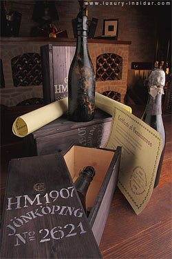 A 100 year old bottle of 1907 Shipwrecked Heidsieck champagne sits on top of a wooden box, fished out from the sea bed of the Gulf of Finland.