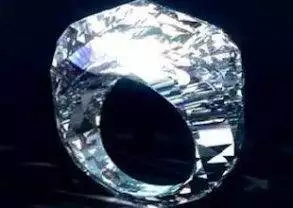A diamond ring with a light shining through it - Shawish Jewelry