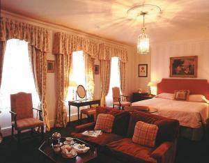 A bedroom with a large bed and a large window in Harrogate.