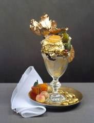 Enjoy your holiday brunch with a gold plated ice cream sundae on a table.