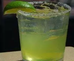 A lime margarita at Johnny Utah's with a lime wedge on top.