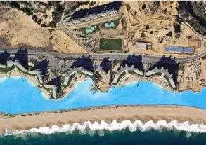 An aerial view of the San Alfonso Del Mar Resort swimming pool near the ocean in Chile.