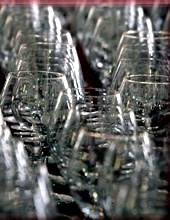 A row of wine glasses on a table, too thin and perfect for sipping Pinot in the rich city of San Francisco.
