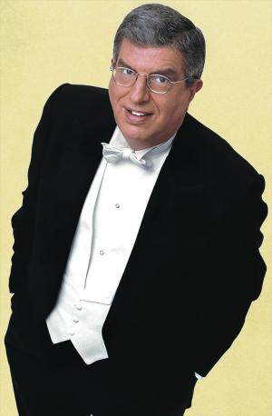 A man in a tuxedo posing for a photo at Venetian rising.