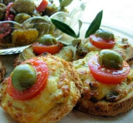 A plate of bread with olives and tomatoes on it served at a Michelin starred gastronomic wonder in Copenhagen.