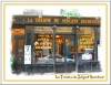 A French bakery storefront with shelves of bread and pastries visible through the window, reminiscent of the charming ambience found in historic restaurants like La Taverne du Sergeant Recruteur, capturing the allure of classic Paris dining.