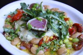 A white plate with tuna, beans and arugula served at Bambara in Salt Lake City.