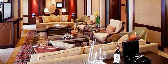 A large living room with cozy couches and a flat screen tv, perfect for relaxation.