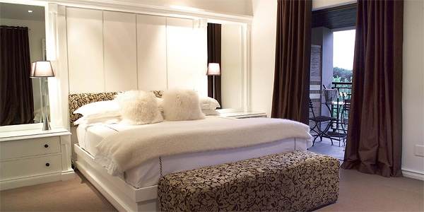 A bedroom with a bed and a dresser, ideal for relaxation.