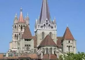 A large cathedral with spires in the background, perfect for a Swiss Girlfriend Getaway in Lausanne.