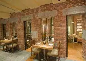 A restaurant with brick walls and tables in Boston, MA.