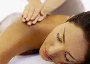 A woman receiving a massage at a spa in NYC.