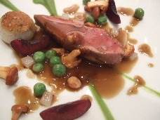 A delicious duck dish on a white plate.