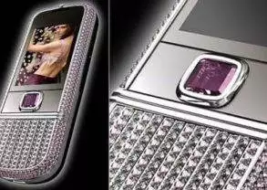 A purple cell phone with sparkling gems on it.