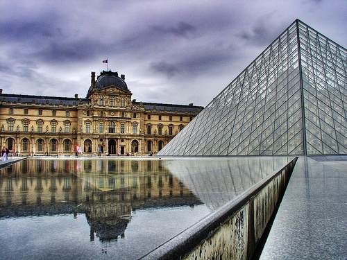 Explore the pyramid of the Louvre in Paris.