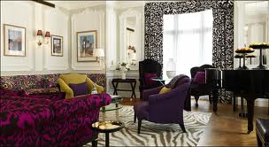 A living room with zebra print furniture and a piano at the heart of London.