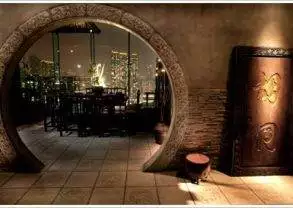 An archway with a door leading to a room with a view of the city, where you can enjoy delicious Chinese cuisine in Hutong.