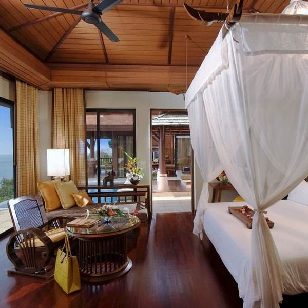 Discover the lost paradise at Pimalai Resort & Spa, where you can experience a bedroom with a canopy bed and an ocean view.