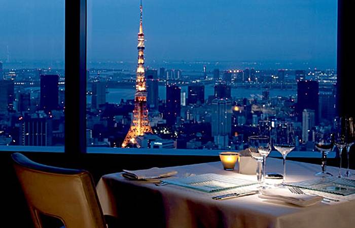 A presidential suite with a view of a city at night.