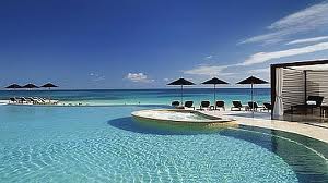 A vacation at Rosewood Mayakoba is a classic experience with lounge chairs and ocean view.