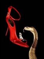 A timeless red shoe adorned with a snake motif.