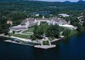An aerial view of The Sagamore Resort, a large mansion on a lake in Bolton Landing, NY.