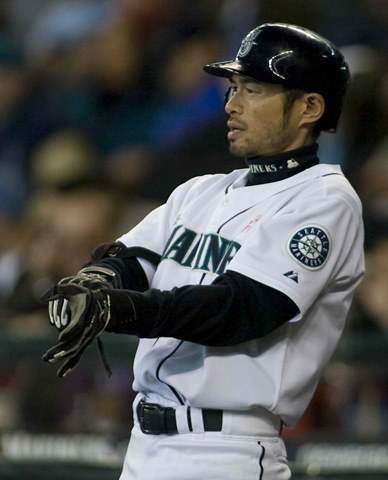 A baseball player in Seattle is holding a bat, making it a Father's Day gift that hits a homer.