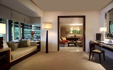 A luxurious hotel room with a bed and a desk.