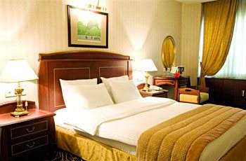 A hotel room with beds, Mediterranean sunlight.
