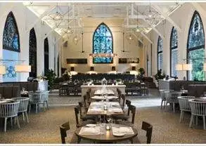 A restaurant with tables and chairs in a church.