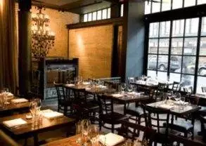 A holiday-themed restaurant with tables, chairs, and a large window in NYC perfect for a girlfriend getaway.